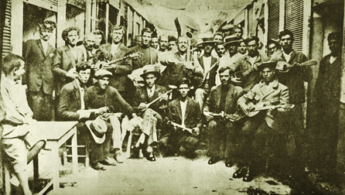 Giorgos Batis (in the middle with guitar) with a group of musicians. Markos Vamavakaris is standing fourth from the left. Piraeus, 1933