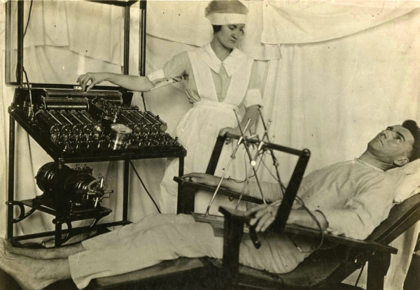 A shell-shocked soldier receives an electrical shock treatment from a nurse. (otis historical archives)