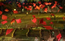 Performers wave large red flags in a large scale live-action show near two theme parks on the outskirts of Wuxiang county in north China's Shanxi province