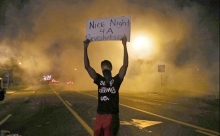 Ferguson rebel holds up sign